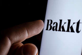 Bakkt company logo on the smartphone screen in a dark.